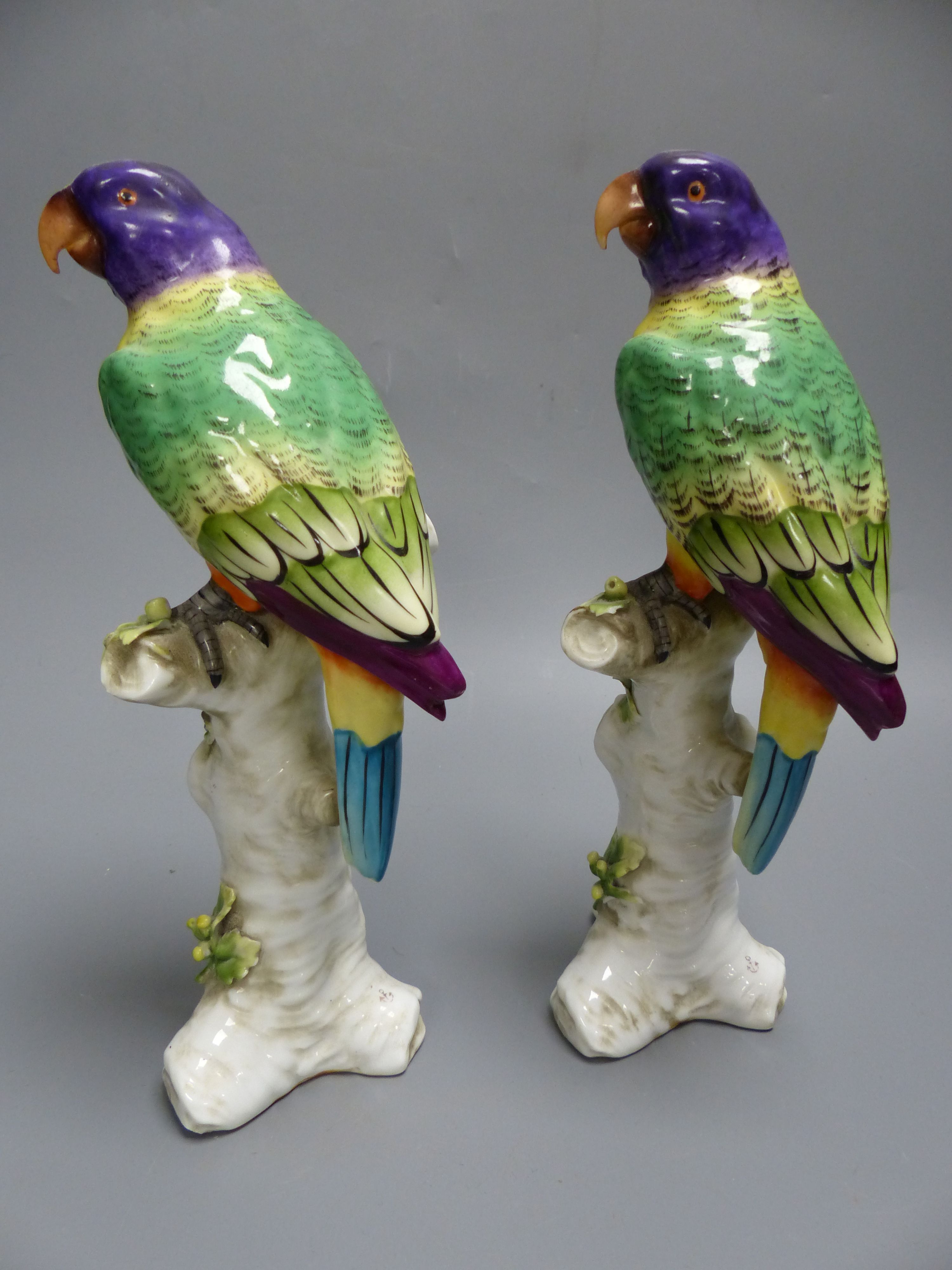 Two Continental porcelain models of parakeets, height 23.5cm